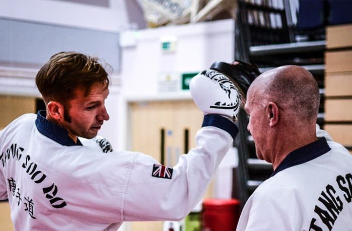 Two adults drilling Tang Soo Do in dobok at ISK Martial Arts