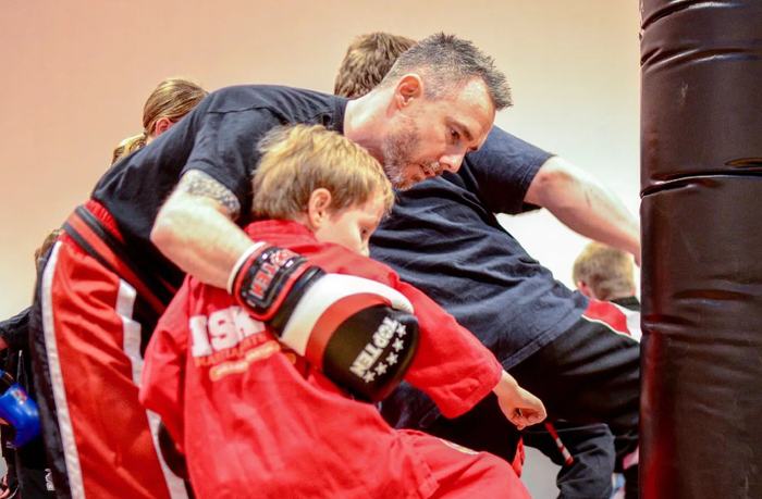 An instructor working with young children at an ISK Martial Arts Tiny Tigers class