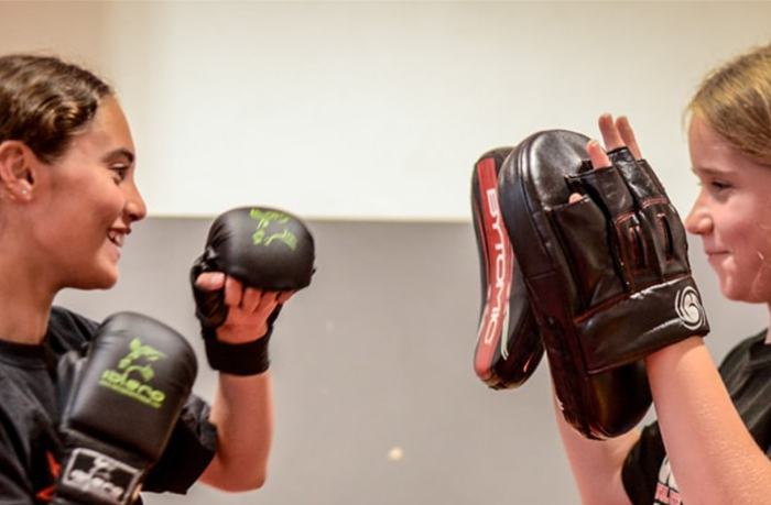 Two juniors holding pads for each other at an ISK Martial Arts Warriors class